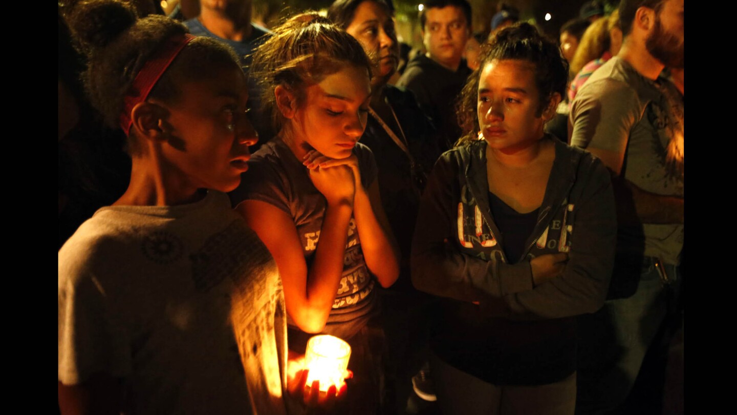 Breanna Garcia, 13, center, mourns the loss of her brother Francisco Garcia with friends Jasmine Johnson, 13, left, and Angelica Maldonado, 13, right at a memorial in Sylmar where he was killed early Nov. 9. Francisco Garcia was an Army veteran.
