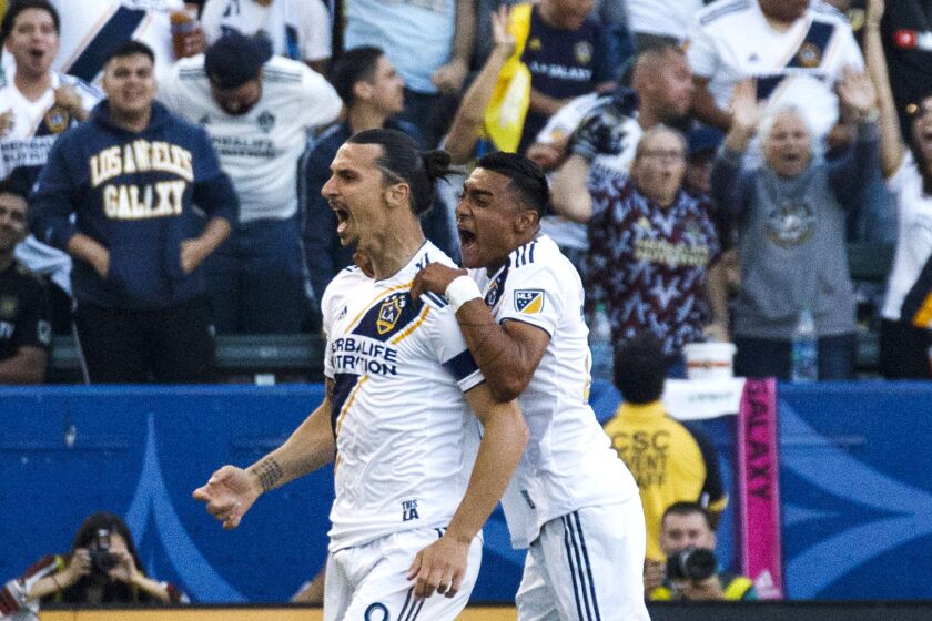 Galaxy forward Zlatan Ibrahimovic (9) celebrates with defender Julian Araujo after scoring a goal during the first half of the game against LAFC on Friday night.