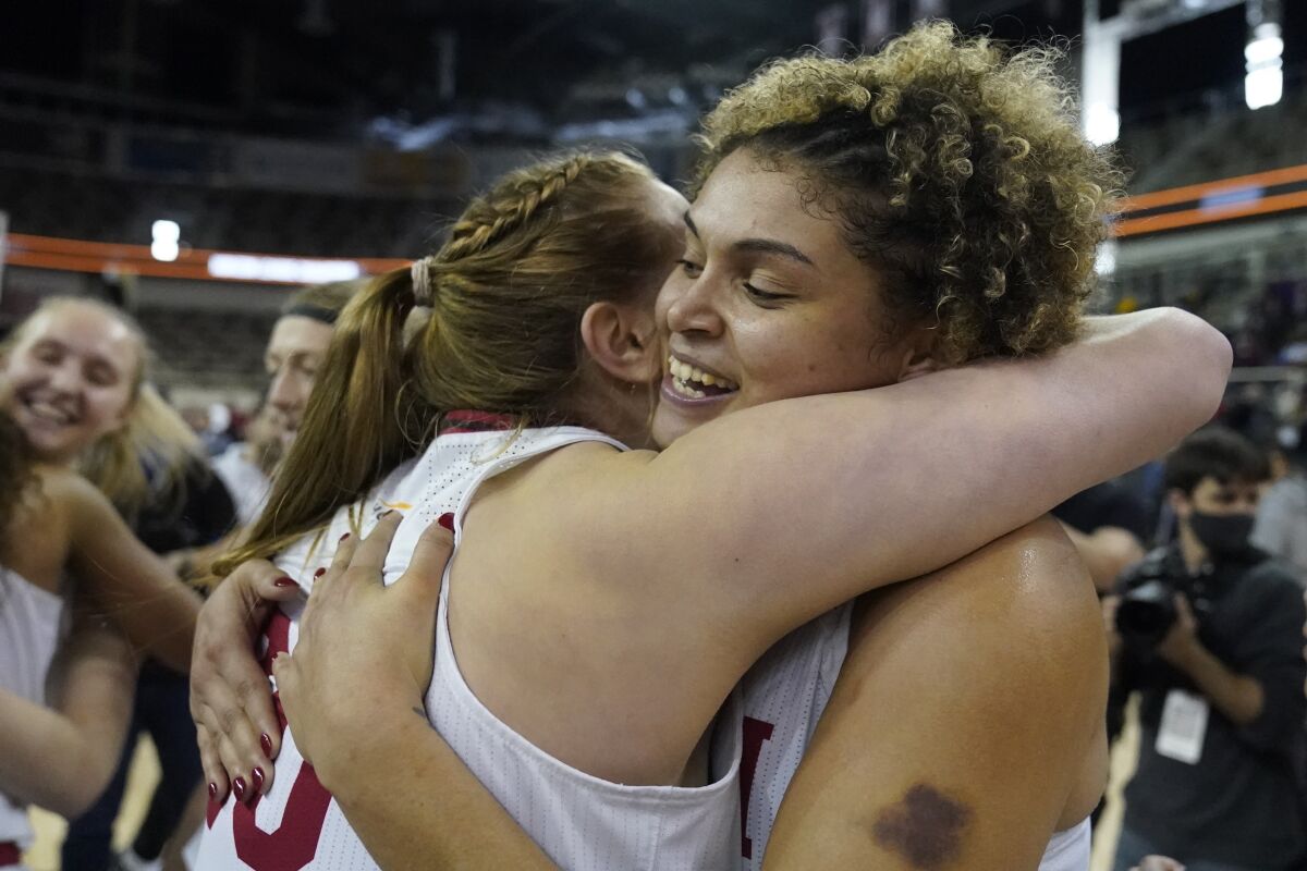 IUPUI's Macee Williams, right, and Morgan Allen celebrate following an NCAA college basketball game against Cleveland State in the Horizon League women's tournament championship, Tuesday, March 8, 2022, in Indianapolis. IUPUI won 61-54. (AP Photo/Darron Cummings)