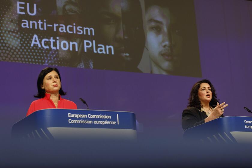 European Commissioner for Values and Transparency Vera Jourova and European Commissioner for Equality Helena Dalli participate in a media conference on the EU anti-racism Action Plan at EU headquarters in Brussels, Friday, Sept. 18, 2020. (AP Photo/Olivier Matthys, Pool)