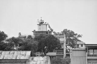 Vietnamese evacuees and a helicopter on a roof