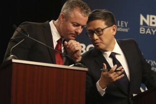 Republican gubernatorial candidate Travis Allen, left, talks with Democratic candidate John Chiang during a debate at the California Theatre, Tuesday, May 8, 2018, in San Jose, Calif.