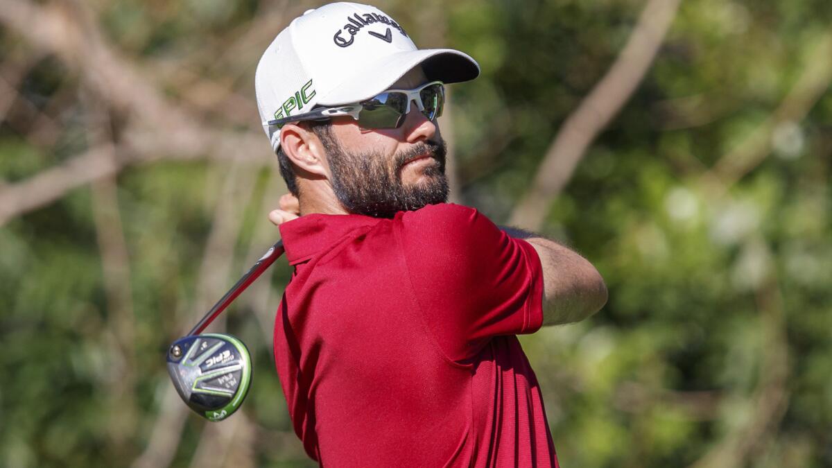 Adam Hadwin follows through on a drive at the 11th hole during the third round of the Valspar Championship on Saturday.