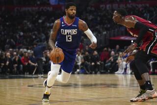 Los Angeles Clippers guard Paul George (13) drives to the basket against Miami Heat center Bam Adebayo during the second half of an NBA basketball game, Monday, Jan. 2, 2023, in Los Angeles. (AP Photo/Allison Dinner)