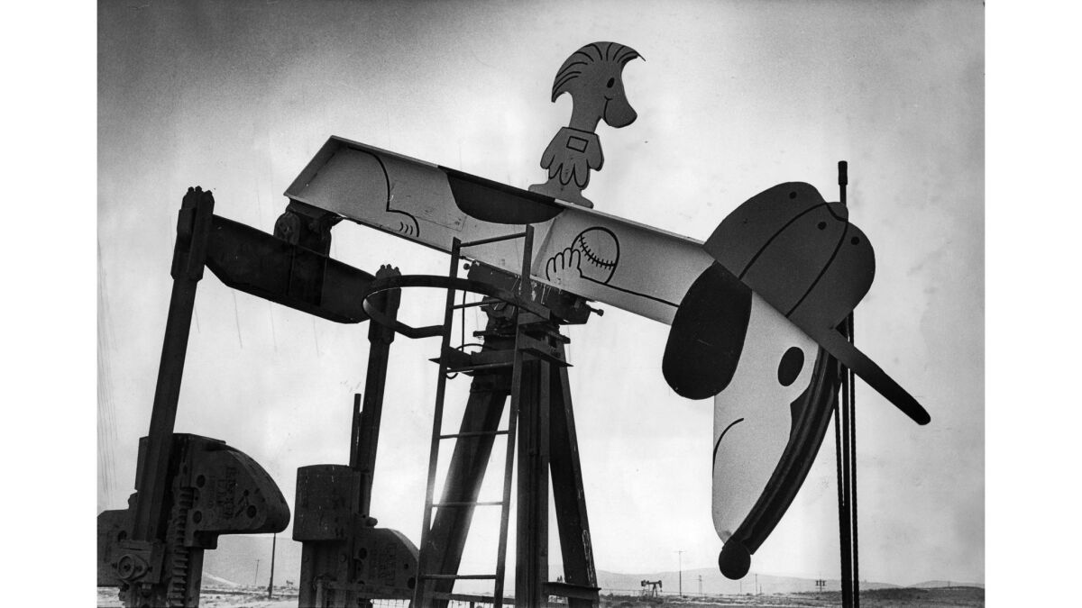 Nov. 20, 1975: Woodstock rides on the back of Snoopy, one of Jean Dakessian's oil well creations near Coalinga.