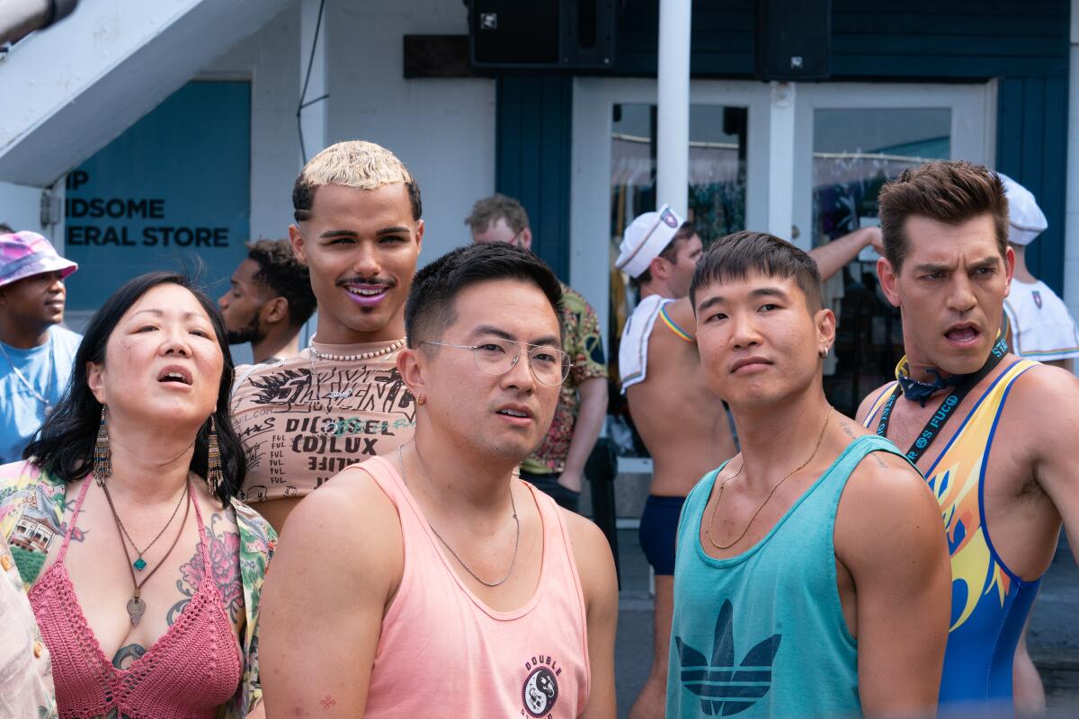 A group in beachwear all looking at something off camera in "Fire Island"