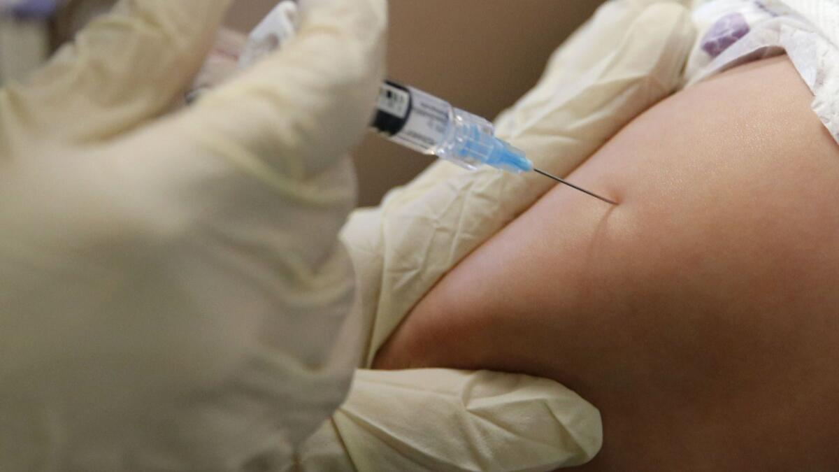 An 8-month-old child is vaccinated at the Dallas County Health & Human Services immunization clinic in Dallas.