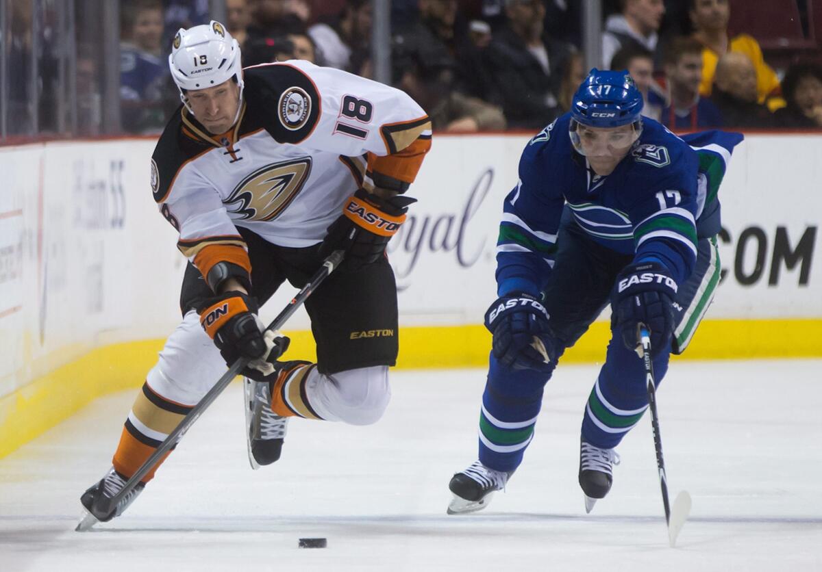 Ducks forward Tim Jackman drives up the right side of the ice against Canucks forward Radim Vrbata. Jackman just signed a one-year extension with the Ducks.