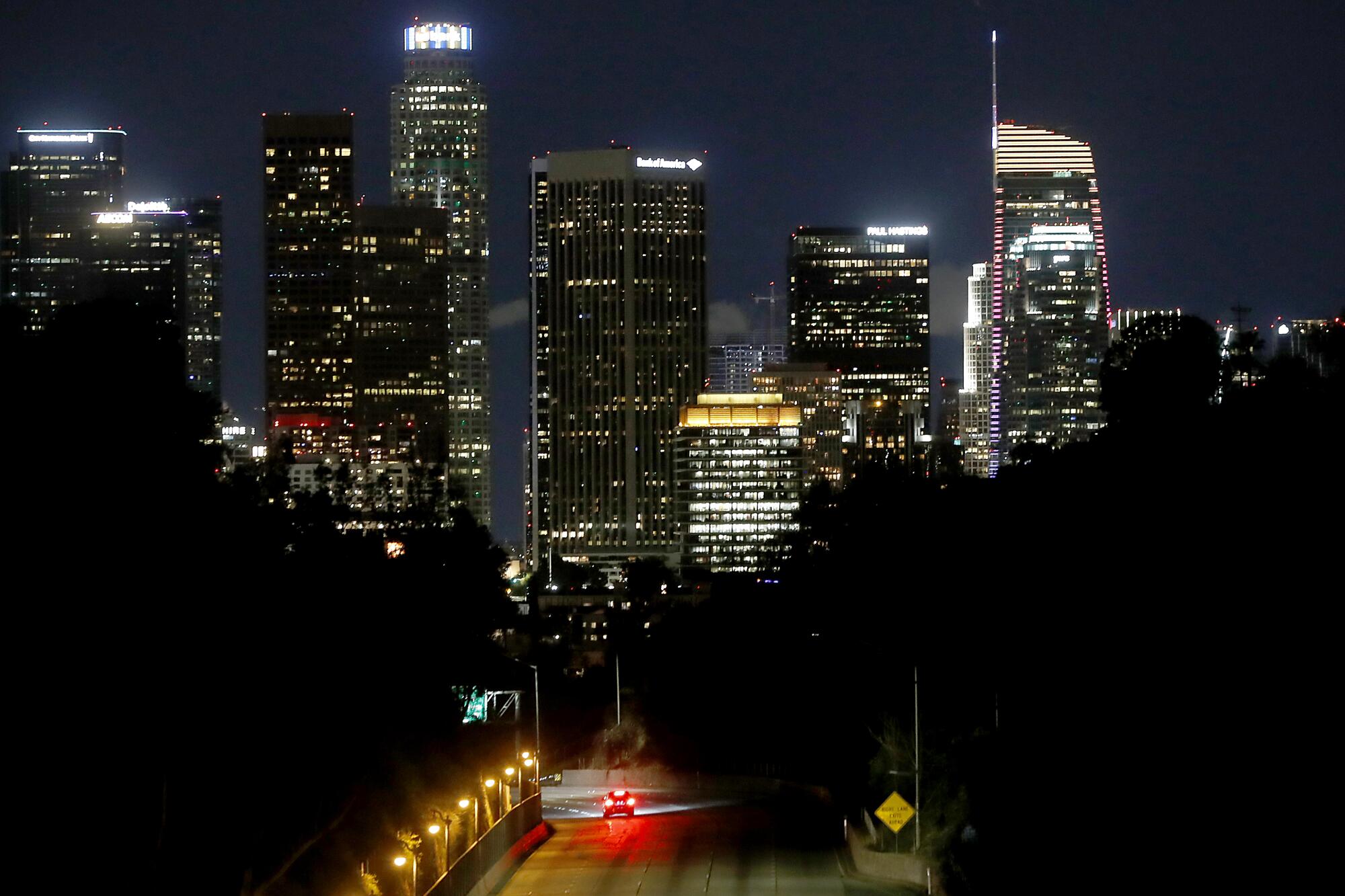 A lone car travels on the Pasadena Freeway in Los Angeles. Traffic on freeways and surface streets has been light as people heed official calls to stay at home.