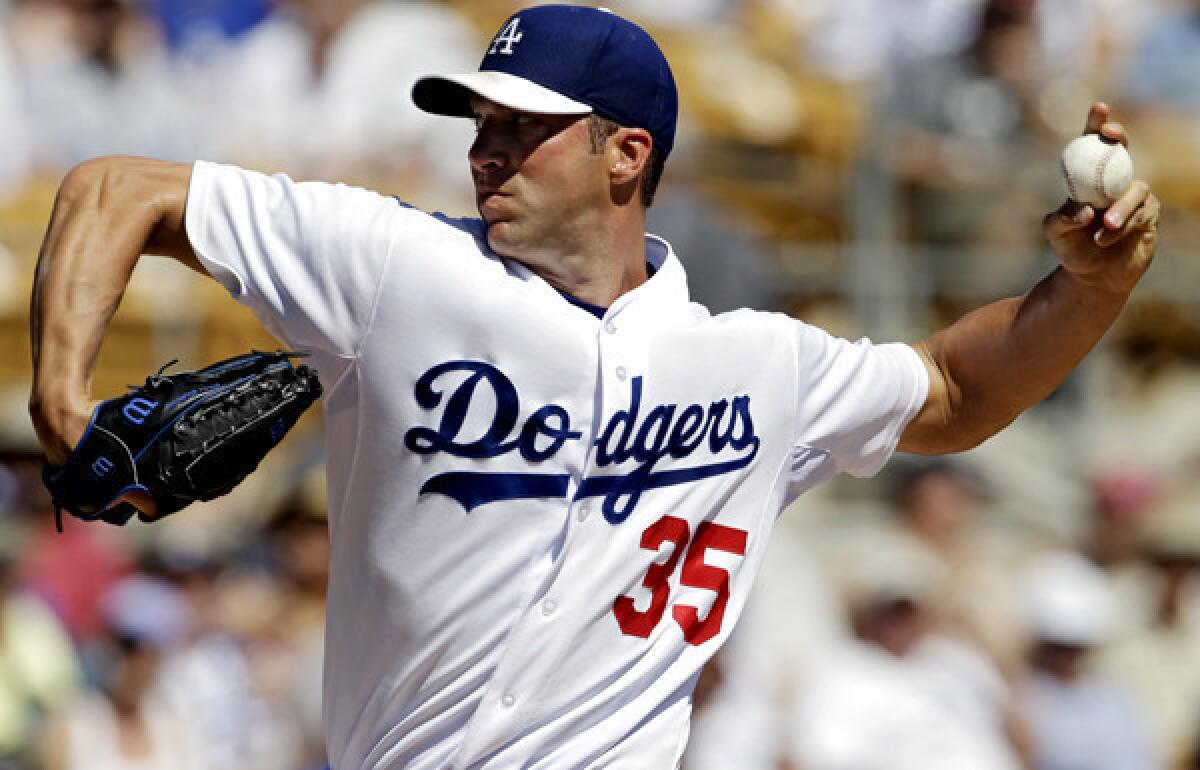 Dodgers starting pitcher Chris Capuano works against the Chicago Cubs in the first inning of a spring training game Thursday.