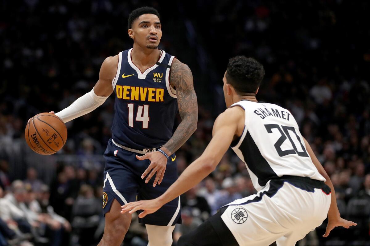 Gary Harris (14) of the Denver Nuggets is guarded by Landry Shamet (20) of the Los Angeles Clippers in the fourth quarter at the Pepsi Center on January 12, 2020 in Denver, CO. (Matthew Stockman/Getty Images/TNS) ** OUTS - ELSENT, FPG, TCN - OUTS **