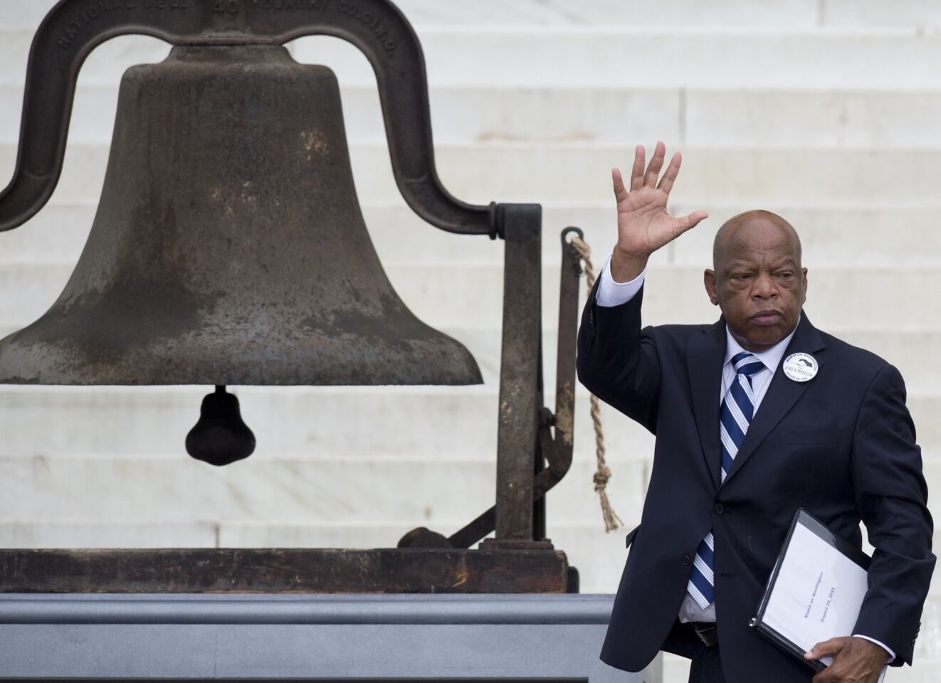 Rep. John Lewis (D-Ga.) waves to the crowd during the commemoration of the 50th anniversary of the March on Washington.