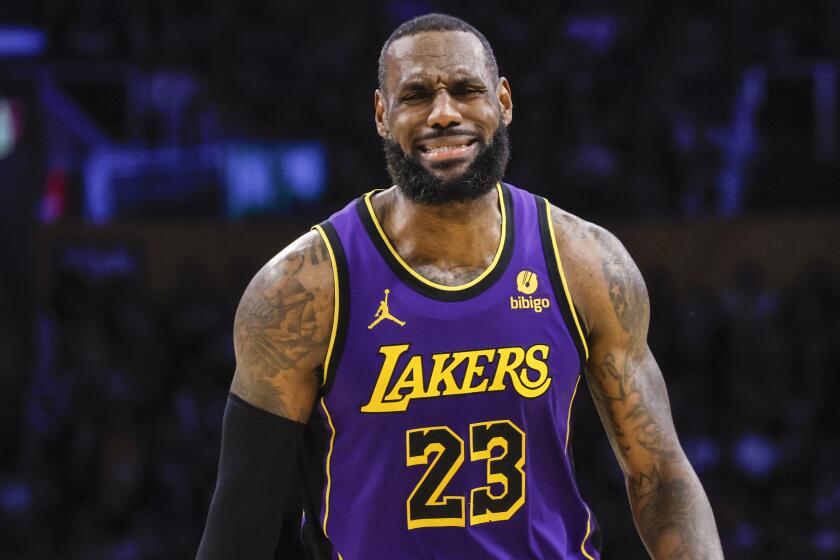 Lakers forward LeBron James expresses his displeasure with a referee's call during Thursday's game against the Suns.