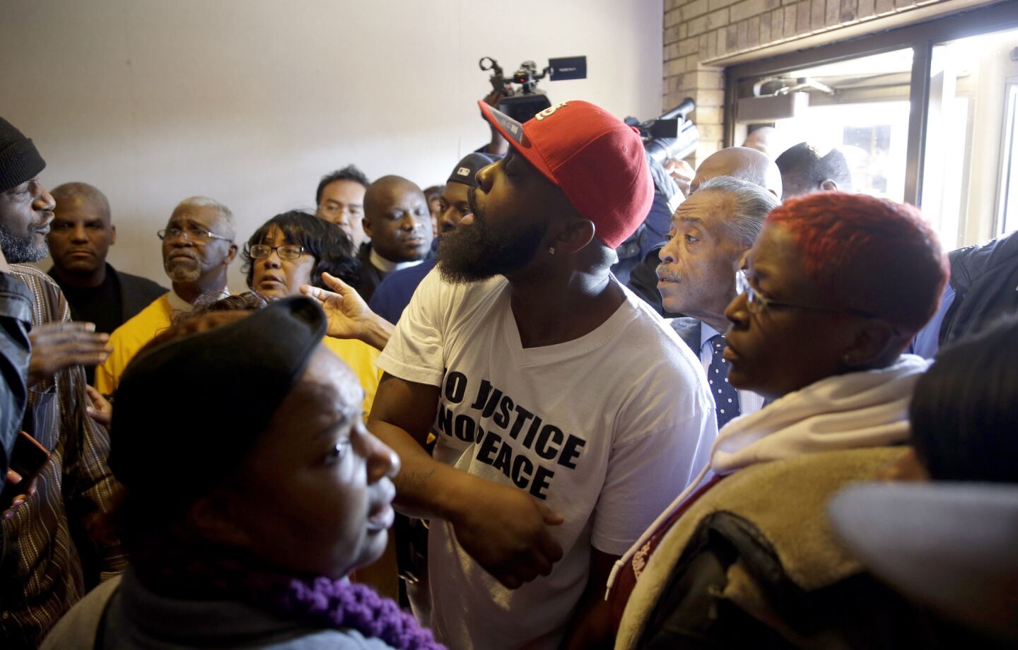 Michael Brown Sr. tries to restore order after an altercation broke out during a news conference at Greater St. Mark Church.