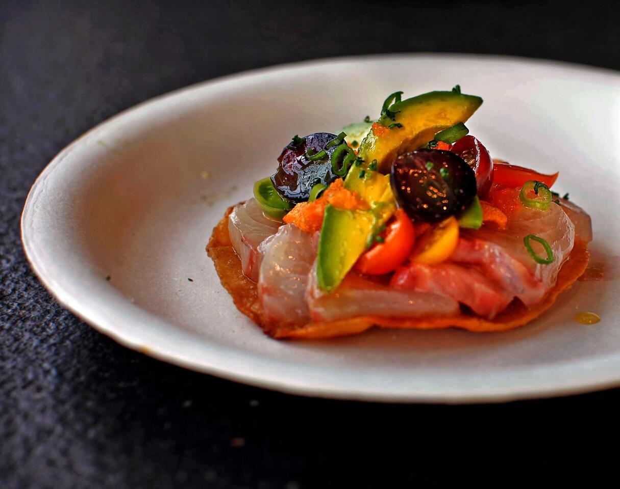 Campechana tostada features raw fish, uni, oysters and tomato salsa.