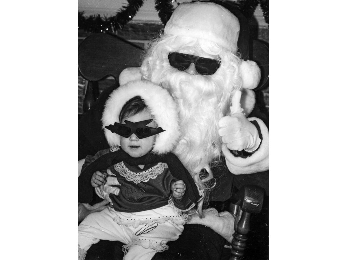 Dec. 8, 1990: Santa wears sunglasses to match Olivia Senecal, 11 months, at the Rolling Hills Plaza. Santa is Los Angeles Times reporter Bob Pool.