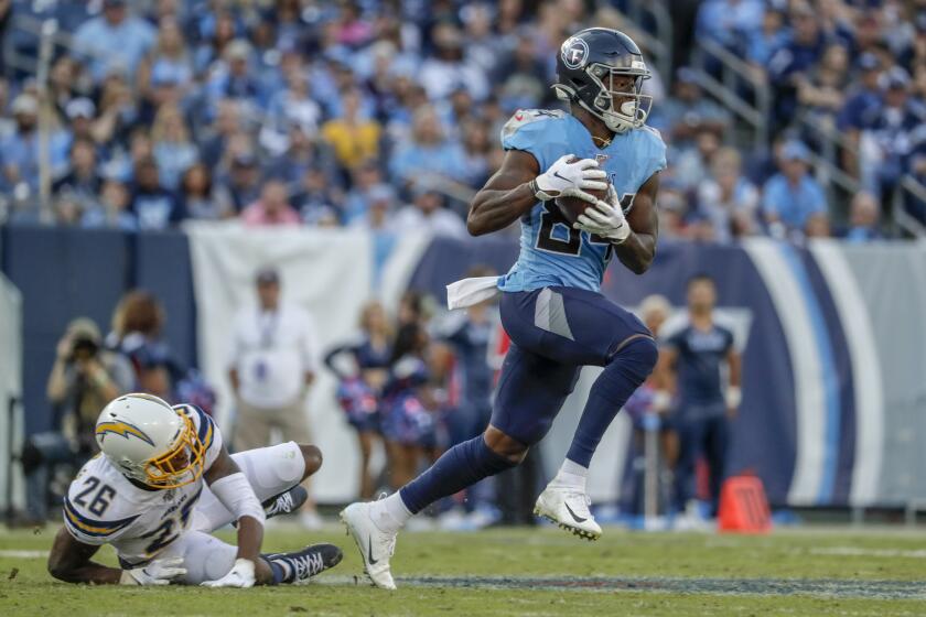 NASHVILLE, TN, SUNDAY, OCTOBER 20, 2019 - Tennessee Titans wide receiver Corey Davis (84) sprints past Los Angeles Chargers cornerback Casey Hayward (26) for a first down on a third down play to keep a fourth quarter scoring drive alive at Nissan Stadium. (Robert Gauthier/Los Angeles Times)