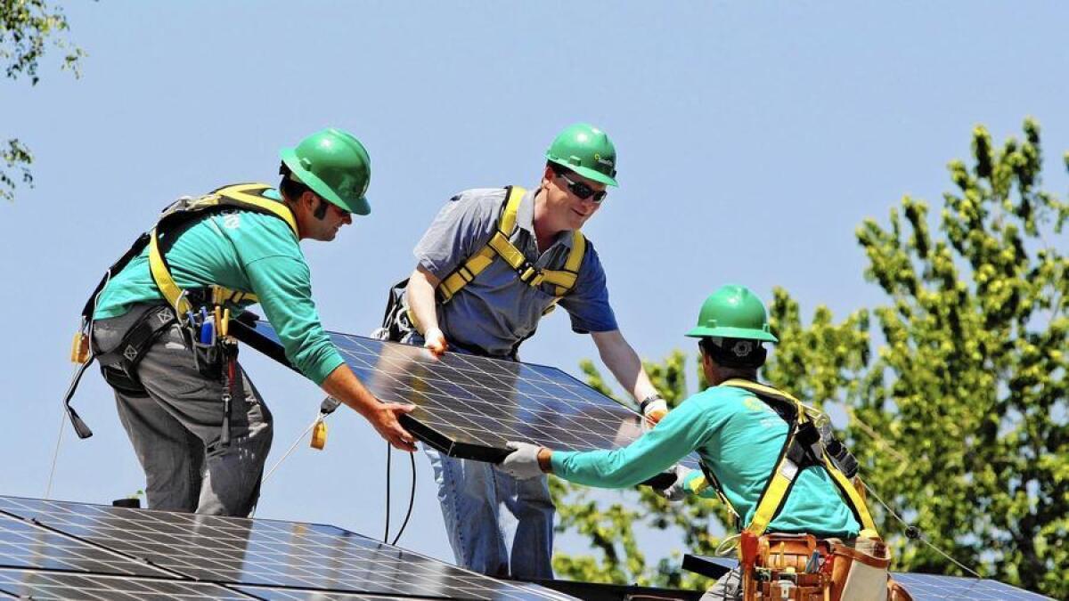 Sen. Michael Bennet (D-Colo.), center, helps as SolarCity employees Jarret Esposito, left, and Jake Torwatzky install rooftop solar panels on a south Denver home in 2010. San Mateo, Calif.-based SolarCity operates in 19 states.