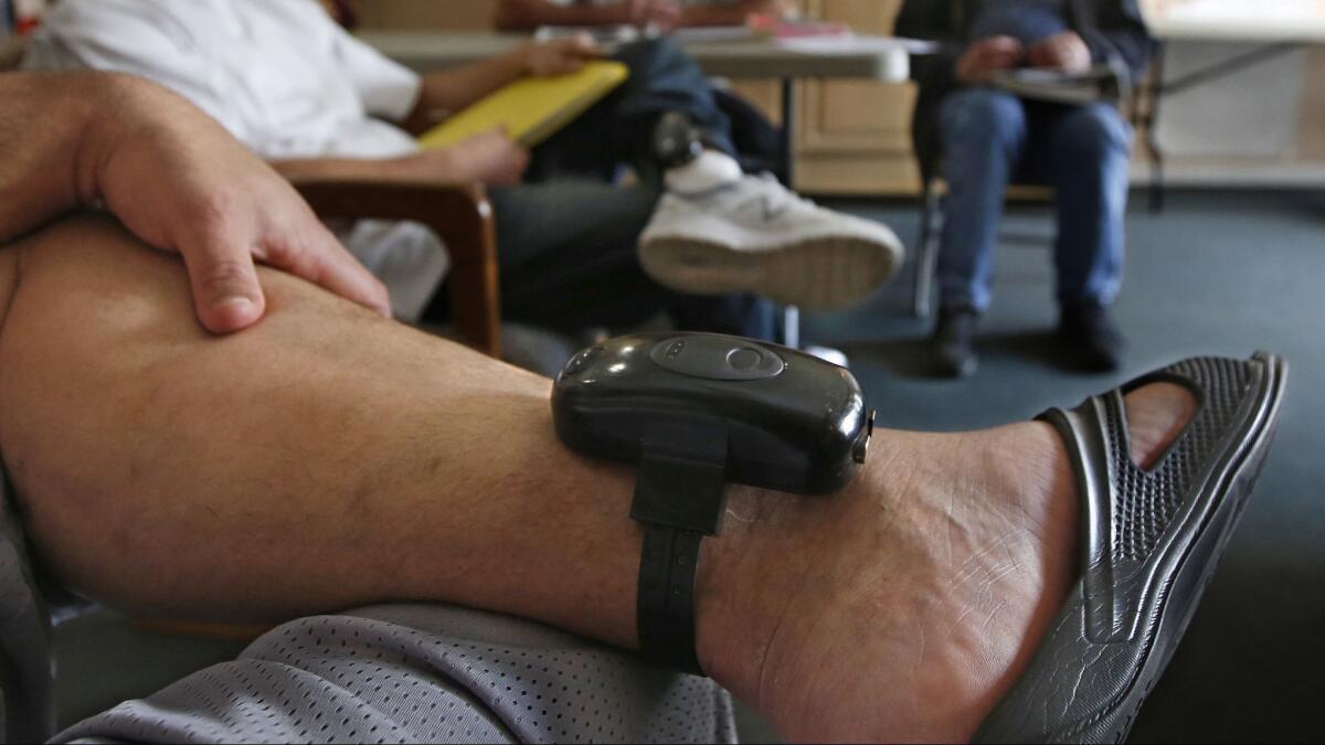 A GPS bracelet is seen on the ankle of an inmate attending a discussion about living in sobriety at the Male Community Re-entry Program in Oroville.