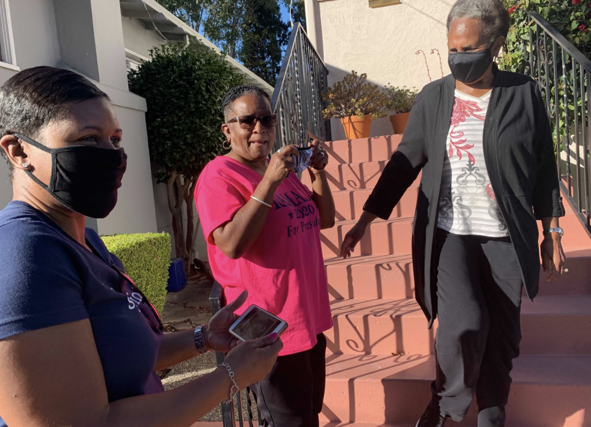 Saniyyah Smith, Sharon McGaffie and Judy Robinson stand on the steps of McGaffie's and Robinson's mother's home.