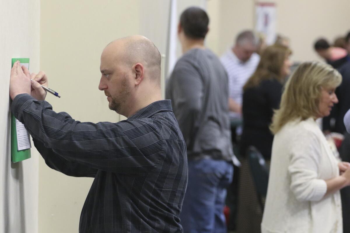 Daniel Marquardt of LaFayette, Ga., fills out an application April 2 at a job fair.