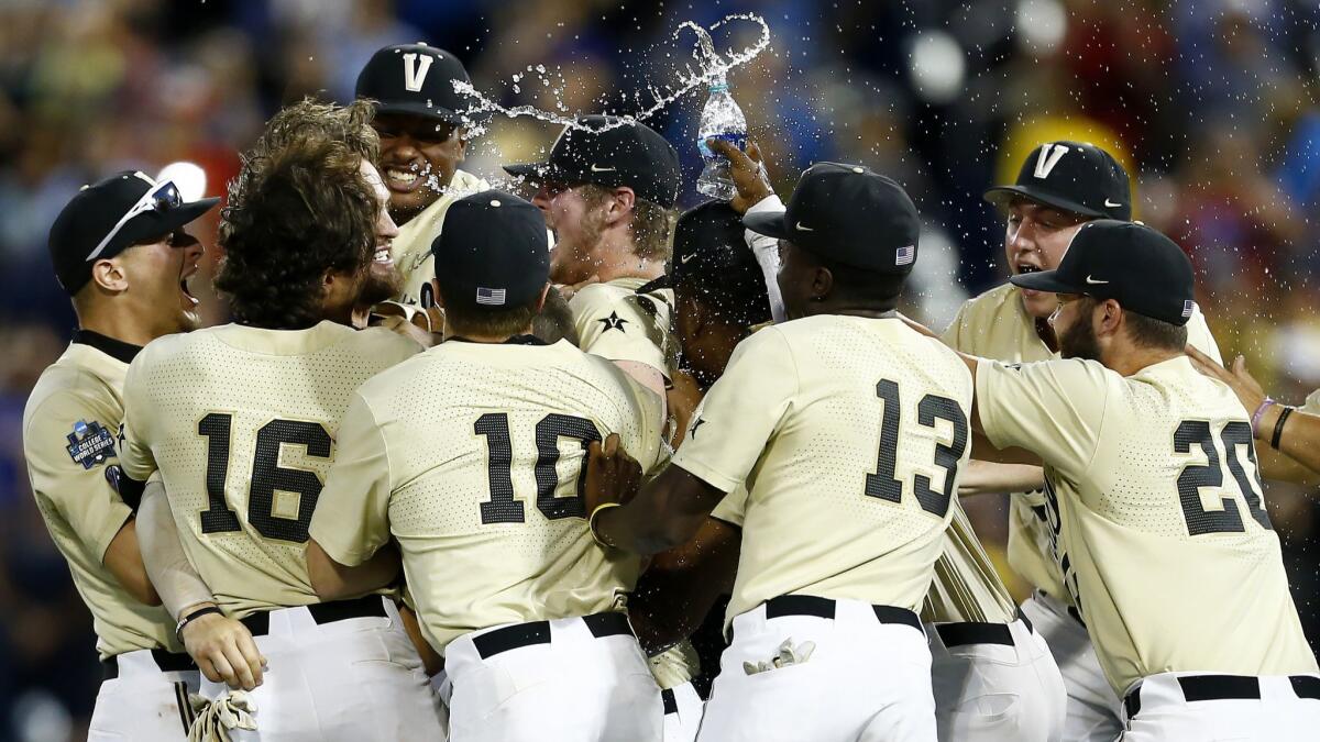 Vanderbilt players celebrate after defeating Michigan in Game 3 of the College World Series in Omaha, Neb. on Wednesday.