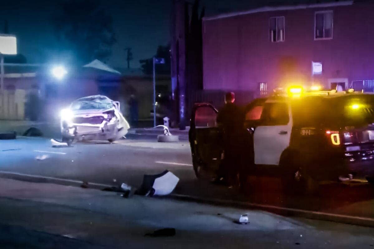 A white SUV is all smashed up in the aftermath of a three-vehicle crash 