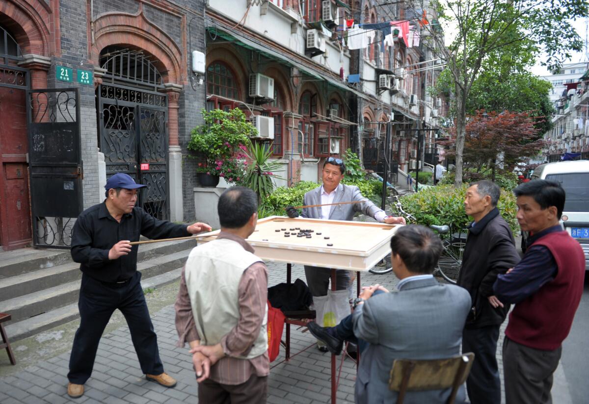 Residents play a board game in Shanghai's former Jewish ghetto.