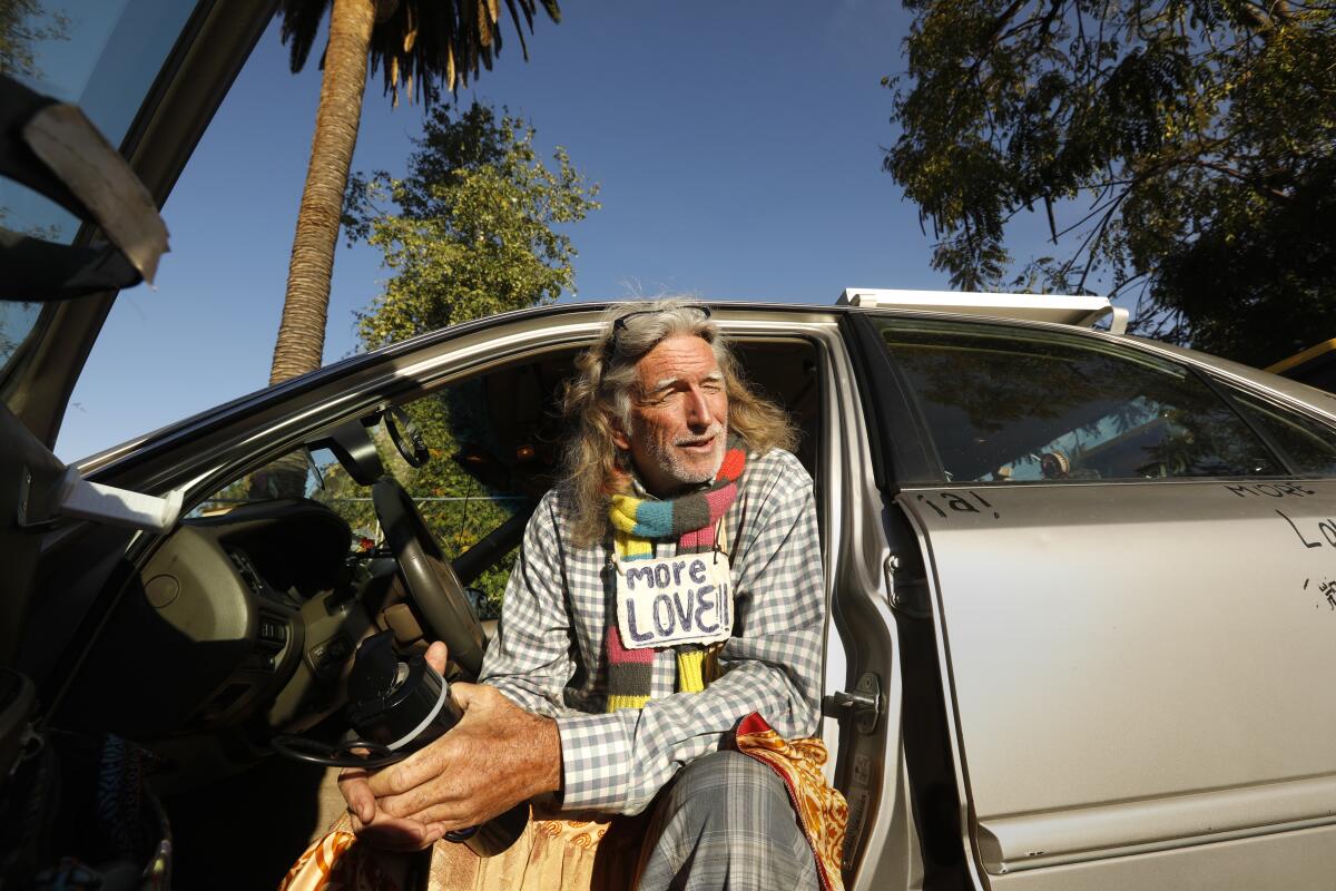 David Busch-Lilly, 66, sits his in car where he lives on Echo Park Avenue.