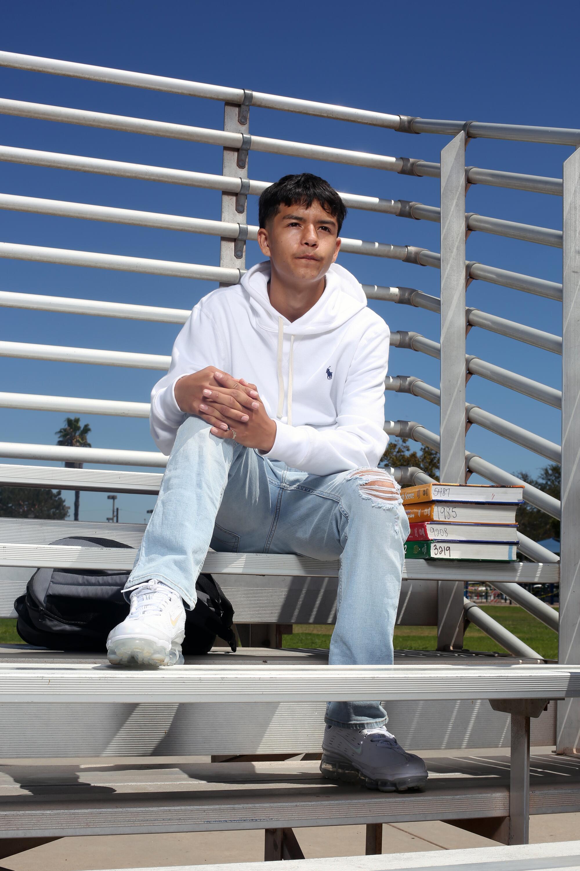 Andrew Diaz, an 11th-grader at Lynwood High, sits in the bleachers at Lynwood Park