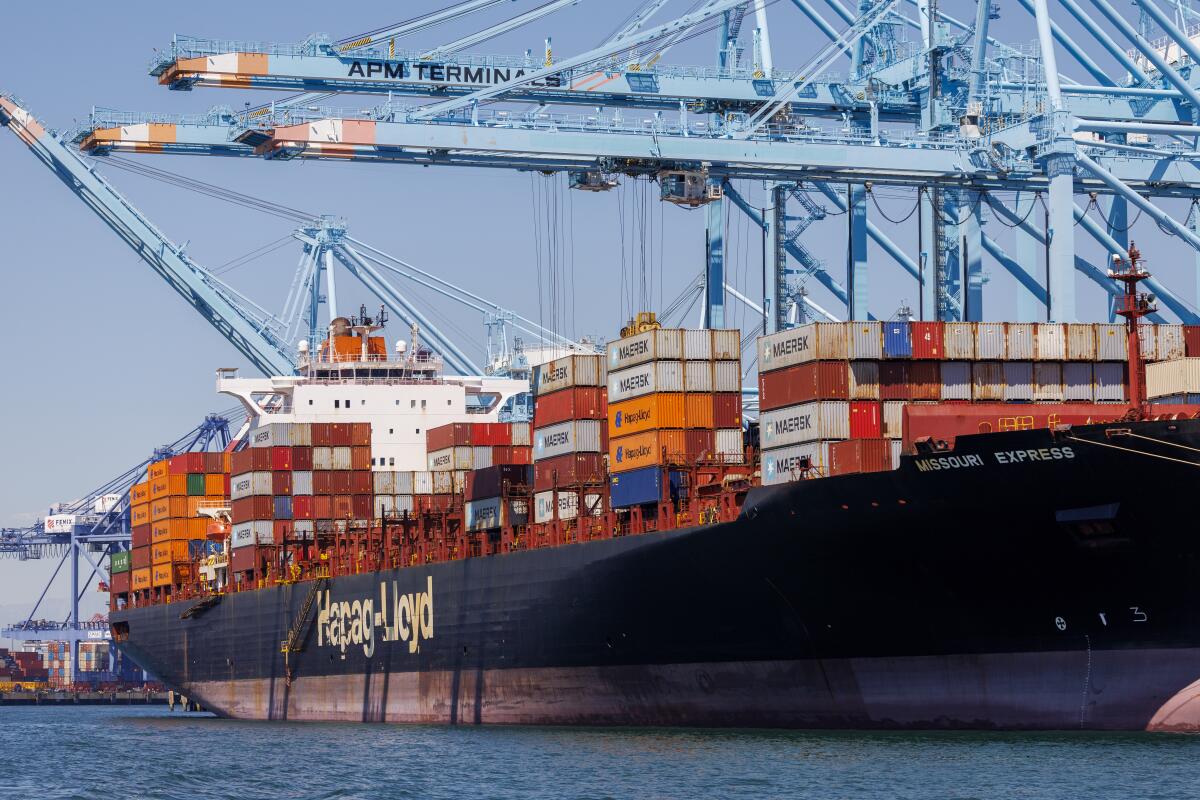 A container ship is among the few unloaded and loaded at the Port of Los Angeles