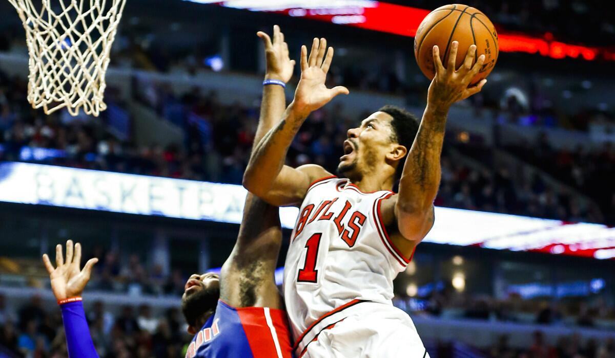 Bulls point guard Derrick Rose goes to the basked against Pistons forward Greg Monroe in the second half of their game Monday.