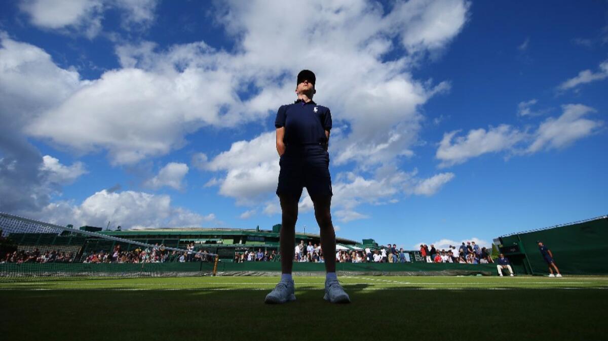 A ball boy looks on from the outdoor courts on day six of the Wimbledon Lawn Tennis Championships at the All England Lawn Tennis and Croquet Club on July 2.