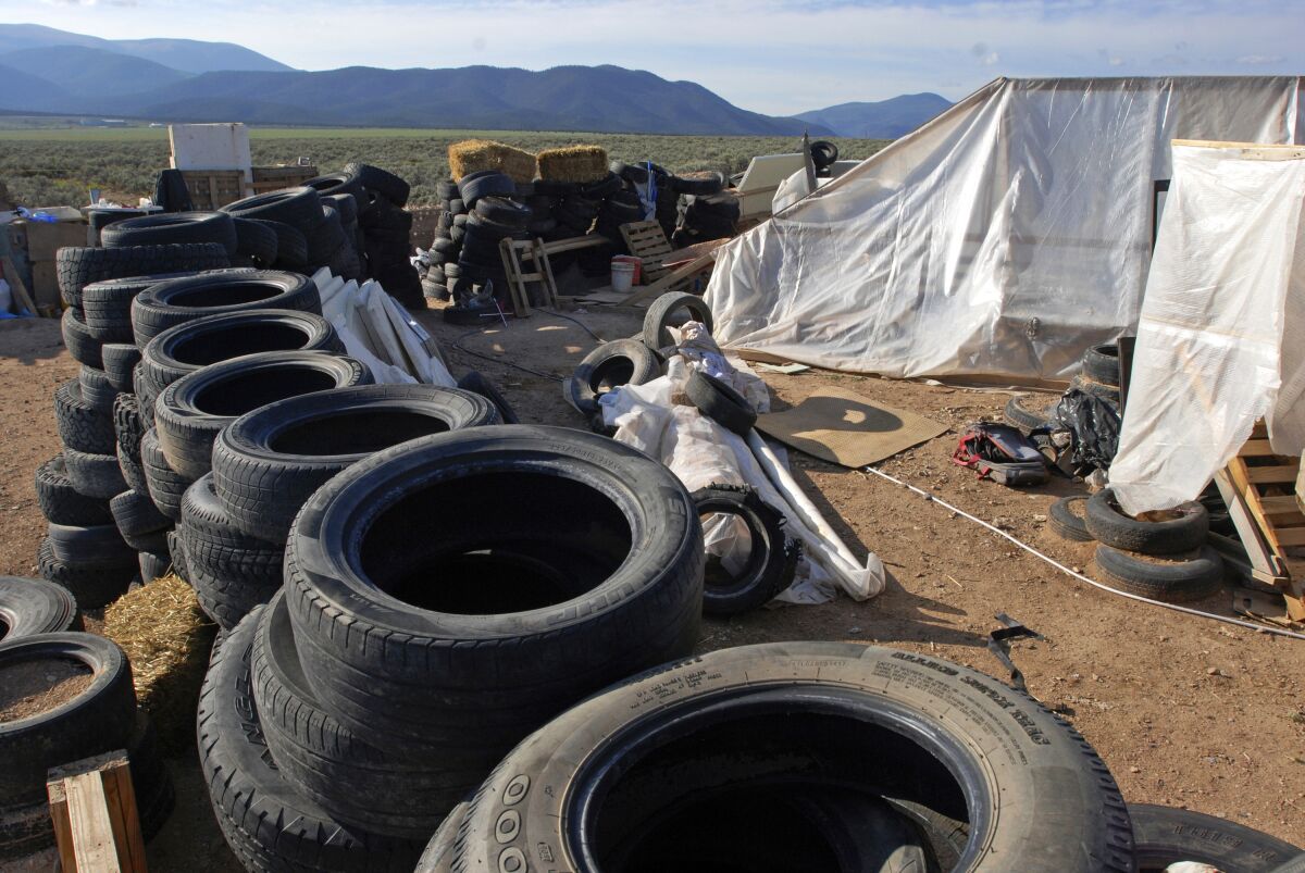 FILE - This Aug. 10, 2018, photo, shows a makeshift living compound in Amalia, N.M. A U.S. district court on Thursday, March 10, 2022, is evaluating the mental health of a woman charged with kidnapping, firearms and terrorism-related counts nearly four years after authorities arrested her and four other adults from an extended family at a squalid New Mexico compound while recovered the remains of a 3-year-old boy. (AP Photo/Morgan Lee, File)