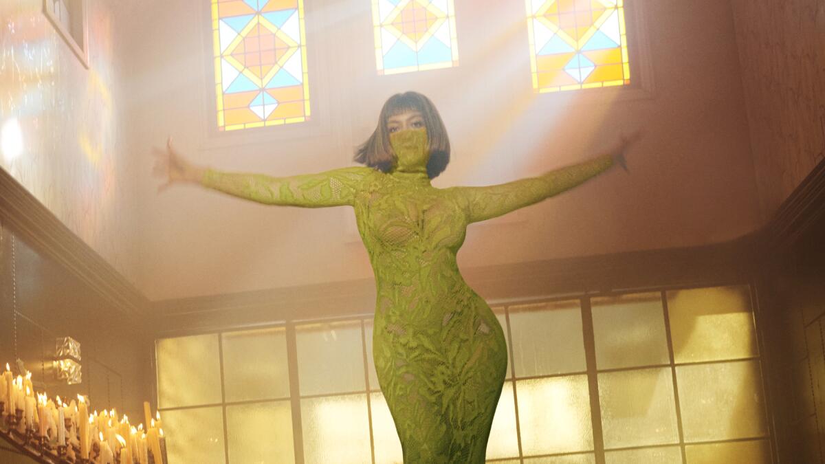 Beyoncé dancing in a green dress