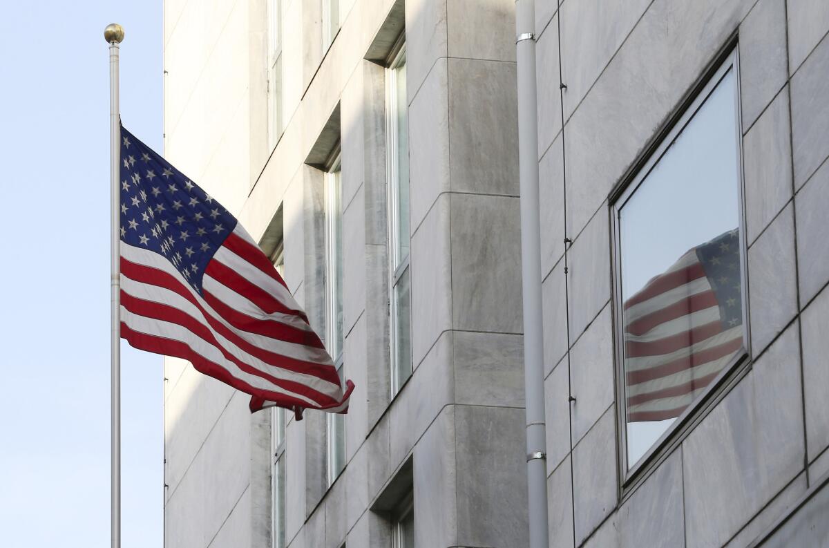 An American flag flies outside the U.S. Consulate in Milan, which was temporarily evacuated Tuesday after receiving a letter containing a bomb threat.