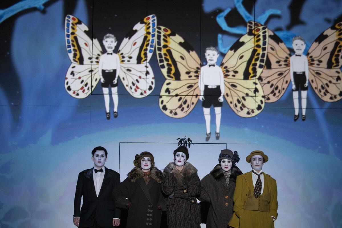 Bogdan Volkov, far left, and Theo Hoffman, far right, appear with the Three Ladies (from left, Erica Petrocelli, Vivien Shotwell and Taylor Raven) in Barrie Kosky’s fanciful, silent movie-era production of Mozart’s “The Magic Flute” at the Dorothy Chandler Pavilion.