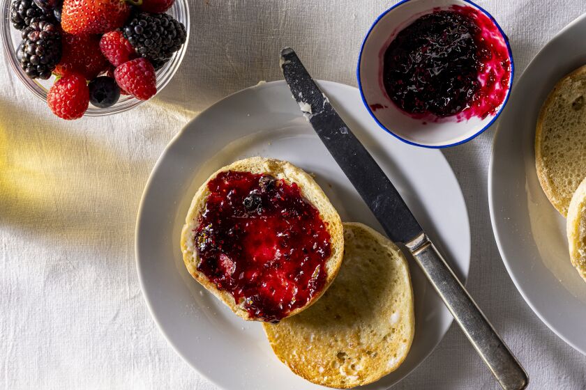 A breakfast scene with English muffins and Summer Pudding Jam made of blueberries, raspberries, strawberries and blackberries