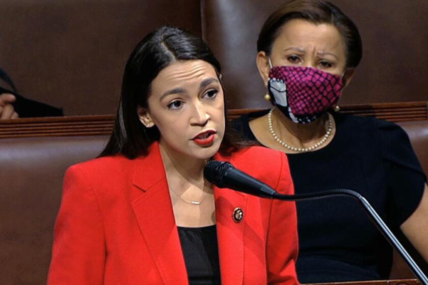 FILE - In this July 23, 2020, file image from video, Rep. Alexandria Ocasio-Cortez, D-N.Y., speaks on the House floor on Capitol Hill in Washington. Rep. Ocasio-Cortez's impassioned remarks on the House floor against the vulgar words of a male colleague and a toxic culture that allows it, have resonated with women who say such language has been tacitly accepted for far too long. Rep. Nydia Velázquez, D-N.Y., is seated right. (House Television via AP, File)