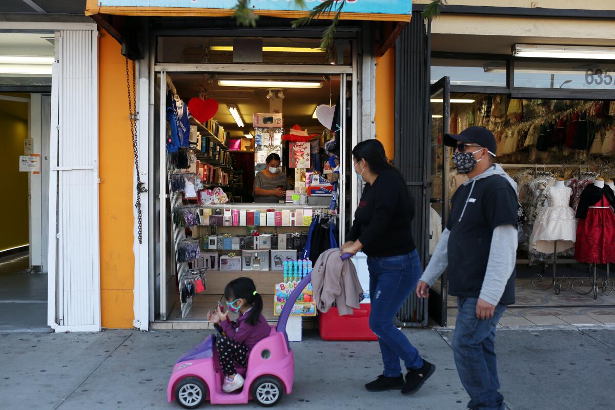 People walk past Orellana's Perfumes in Huntington Park.