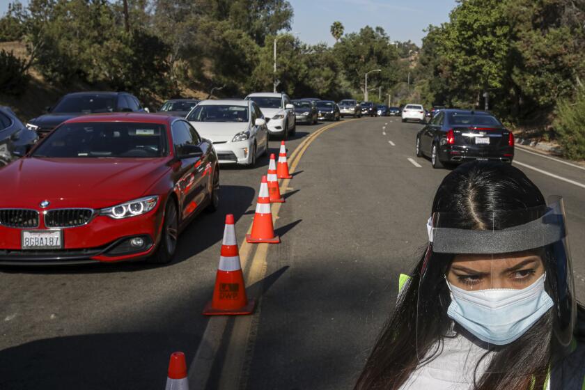 LOS ANGELES, CA - NOVEMBER 11: Due to Covid-19 spike Mayor Eric Garcetti has expand 8 a.m to 8 p.m for coronavirus testing time at Dodger Stadium. A huge number residents converge for COVID-19 test at Dodger Stadium on Wednesday, Nov. 11, 2020 in Los Angeles, CA. (Irfan Khan / Los Angeles Times)