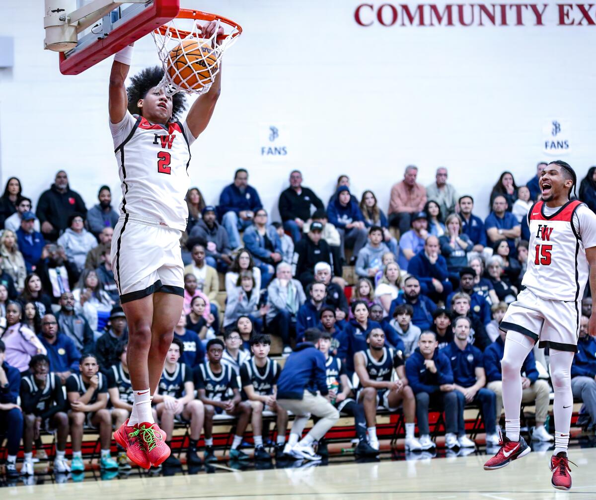 Robert Hinton skies for a dunk as teammate Christian Horry celebrates. Harvard-Westlake routed St. John Bosco.