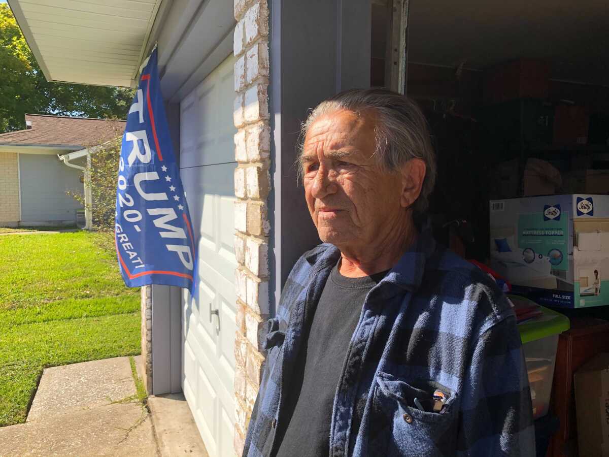 Tom Donohoe outside his La Porte, Texas, home, which is flying a "Trump 2020" flag.