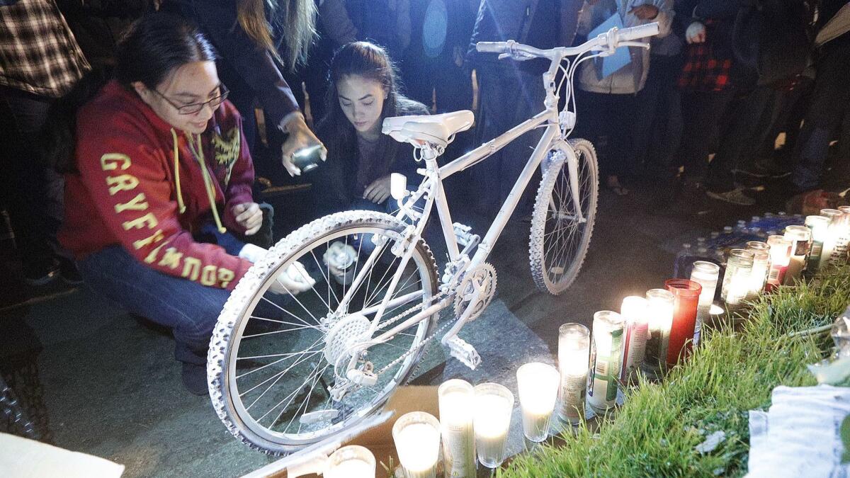 Amanda and Rose Trinh spray white paint onto a bike that symbolizes a "ghost bike" to represent the lost life of their brother Lenny Trinh on the 1300 block of Alameda Avenue in Burbank. A local cyclist writes to thank the Leader for coverage of the ceremony.