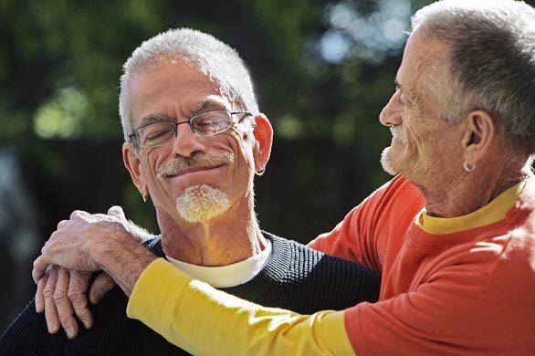 WERE STILL HERE: Dennis Golay, 60, left, and Larry Gibson, 63, in the garden of their Palm Springs home. Both men tested positive for HIV in the days before antiretroviral drugs.