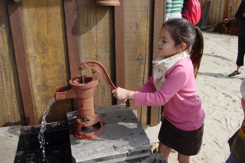 A girl learns how early settlers pumped their own water at the San Dieguito Heritage Museum. Water has always been precious in the area. Courtesy photo