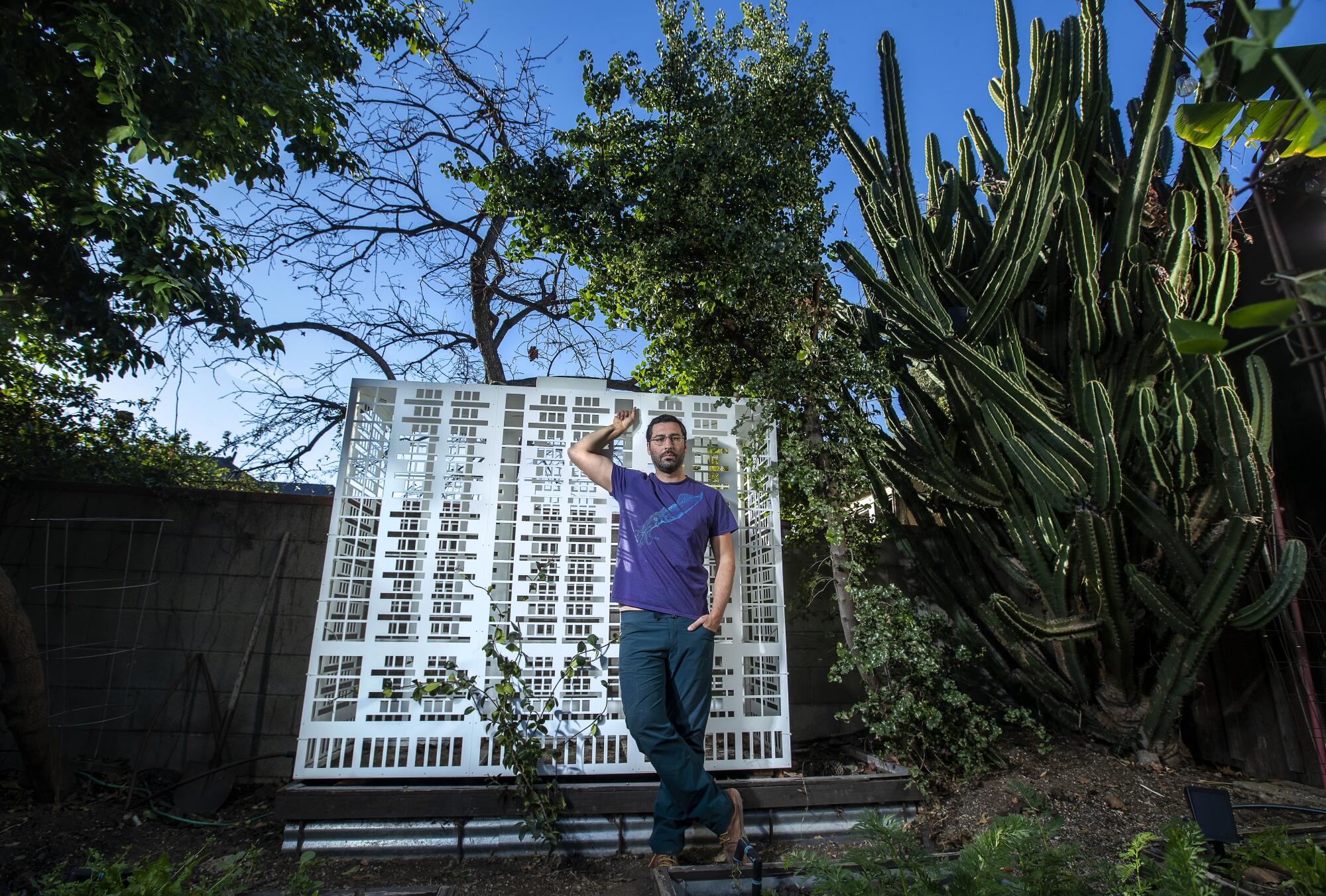 director Lars Jan photographed in his Echo Park backyard with one his laser-cut aluminum sculptures.
