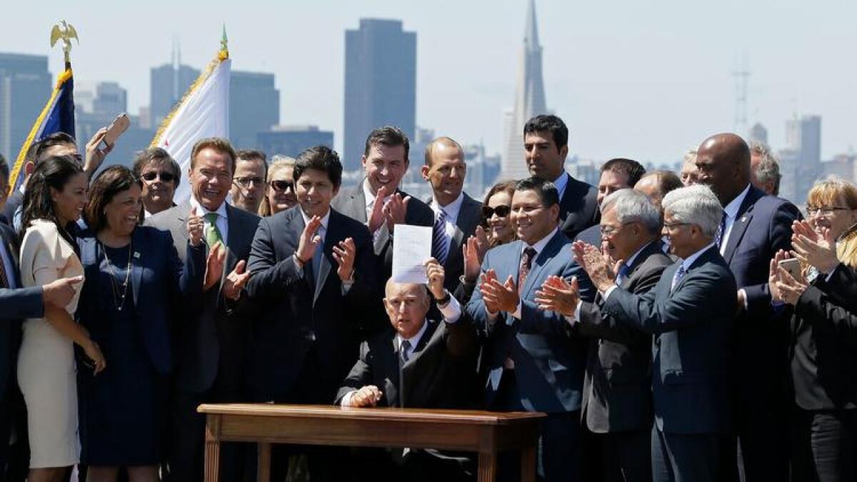 Gov. Jerry Brown signs an extension of California's cap-and-trade program in July.