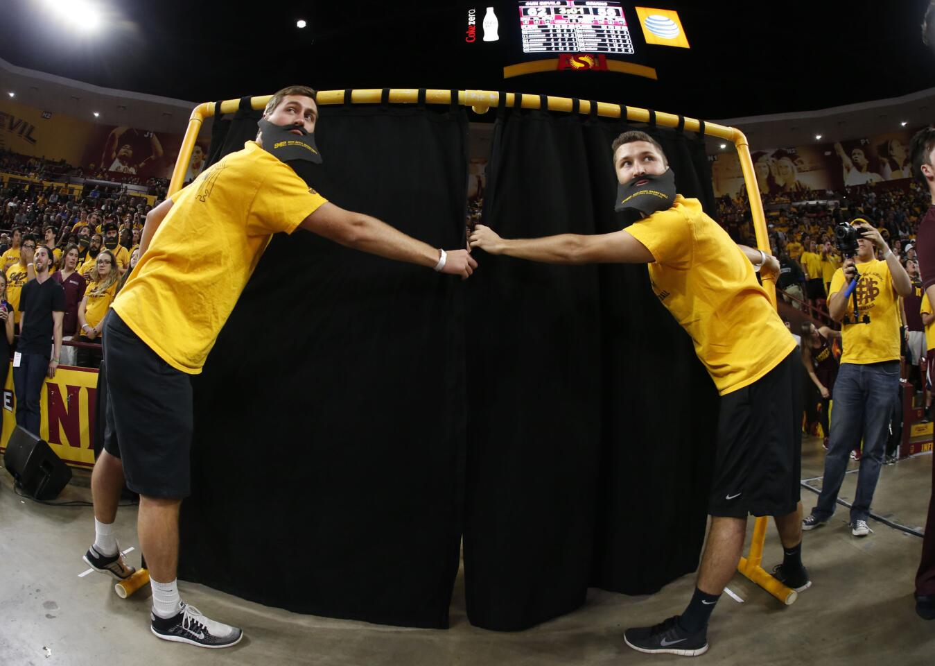 Arizona State fans prepare to unveil their Curtain of Distraction during the second half of a game against UCLA on Feb. 18 in Tempe, Ariz.