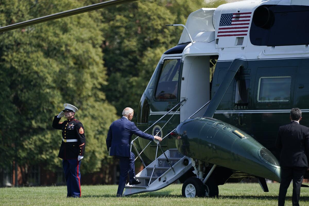 President Biden boards a helicopter.